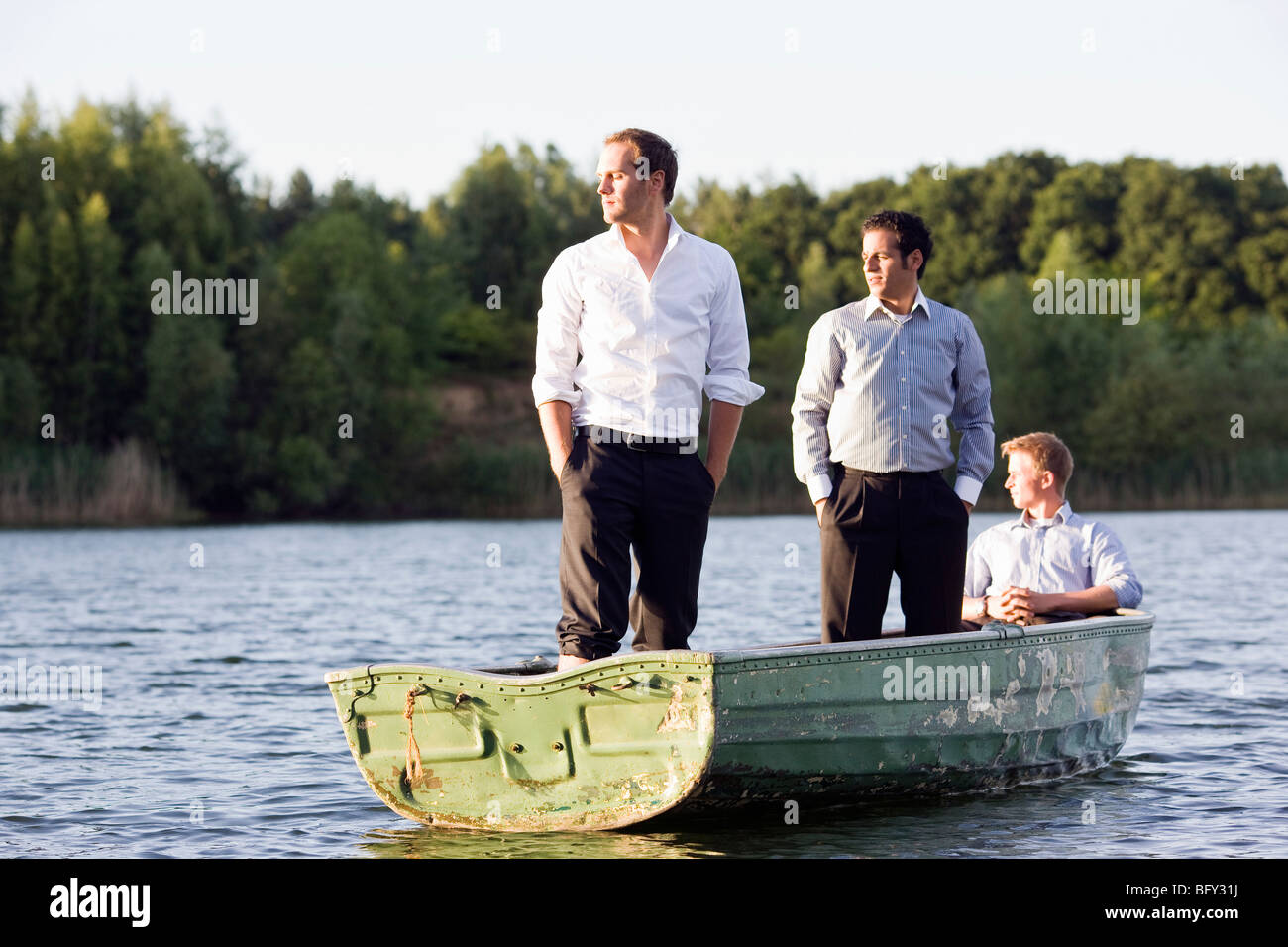 three businessmen in rowboat Stock Photo
