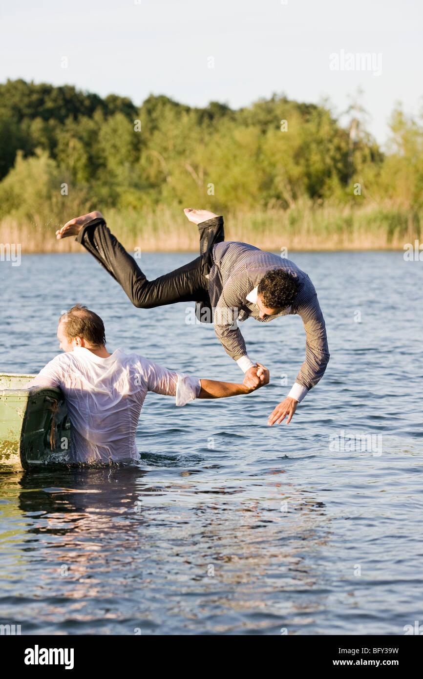 businessman throwing friend in water Stock Photo Alamy