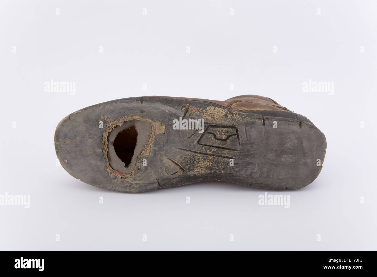 One old and worn shoe with hole on sole on white background Stock Photo -  Alamy