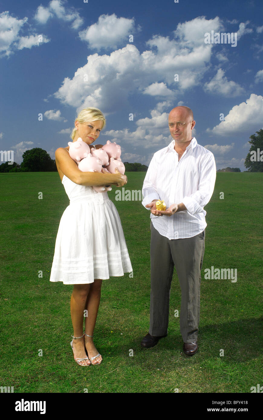 couple holding piggy banks Stock Photo - Alamy