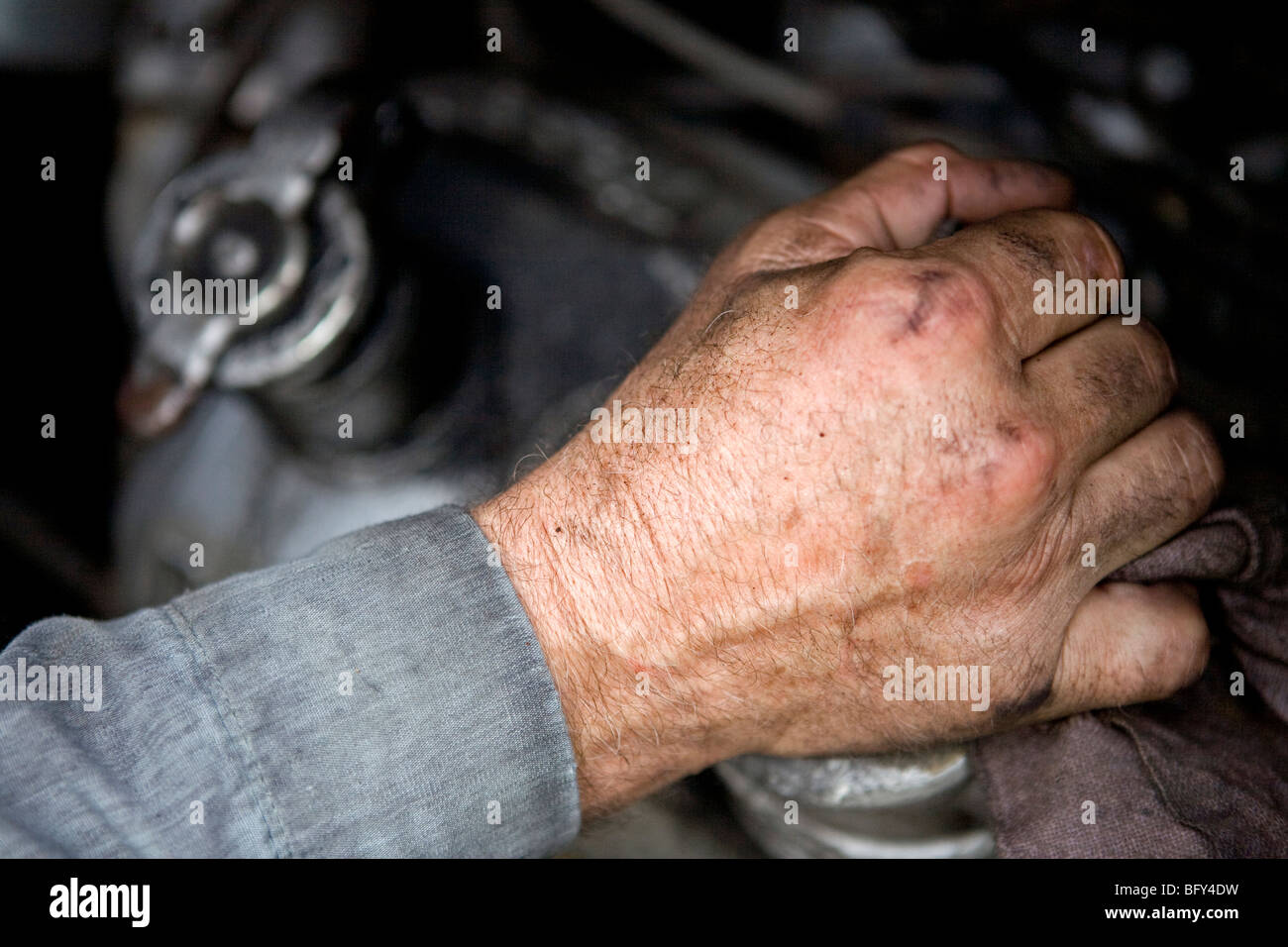 Mechanic's hand working on a diesel engine Stock Photo
