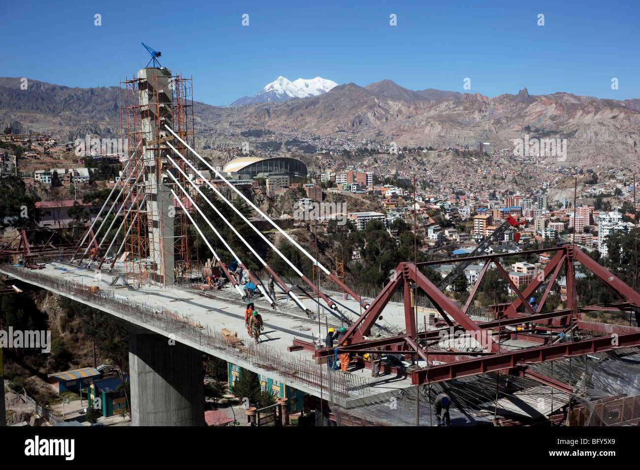 Puente de los Trillizos cable-stayed bridge construction site above Av Kantutani, Mt Illimani in background, La Paz, Bolivia Stock Photo