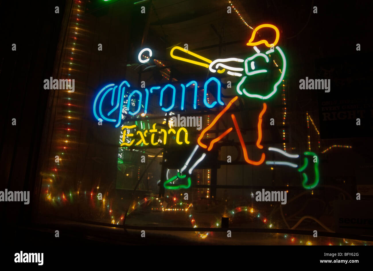 An illuminated neon sign advertising Corona Extra Mexican beer in the window of a bar in Williamsburg, Brooklyn Stock Photo