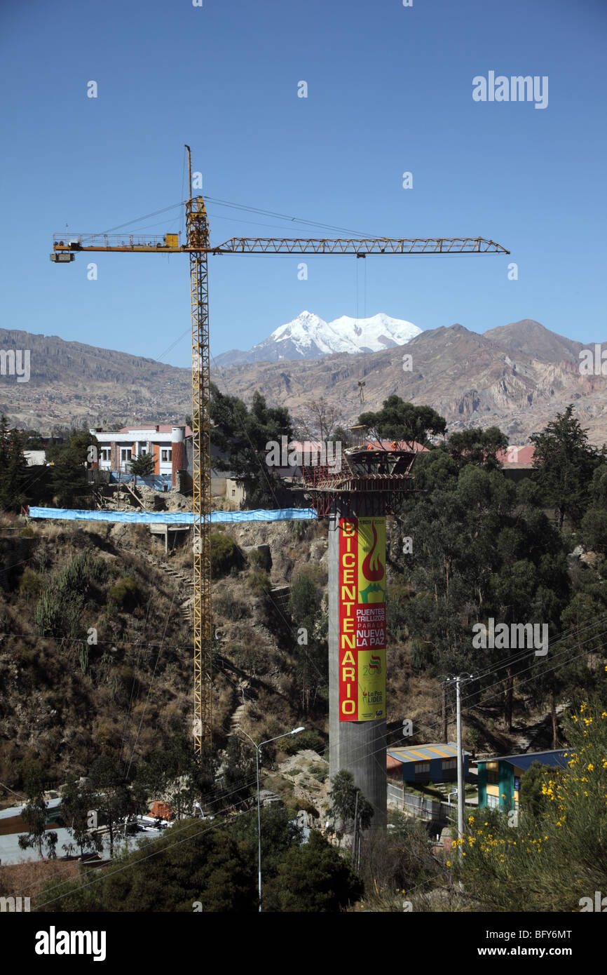 Tower crane on Puente de los Trillizos bridge construction site, Mt Illimani in background, La Paz, Bolivia Stock Photo