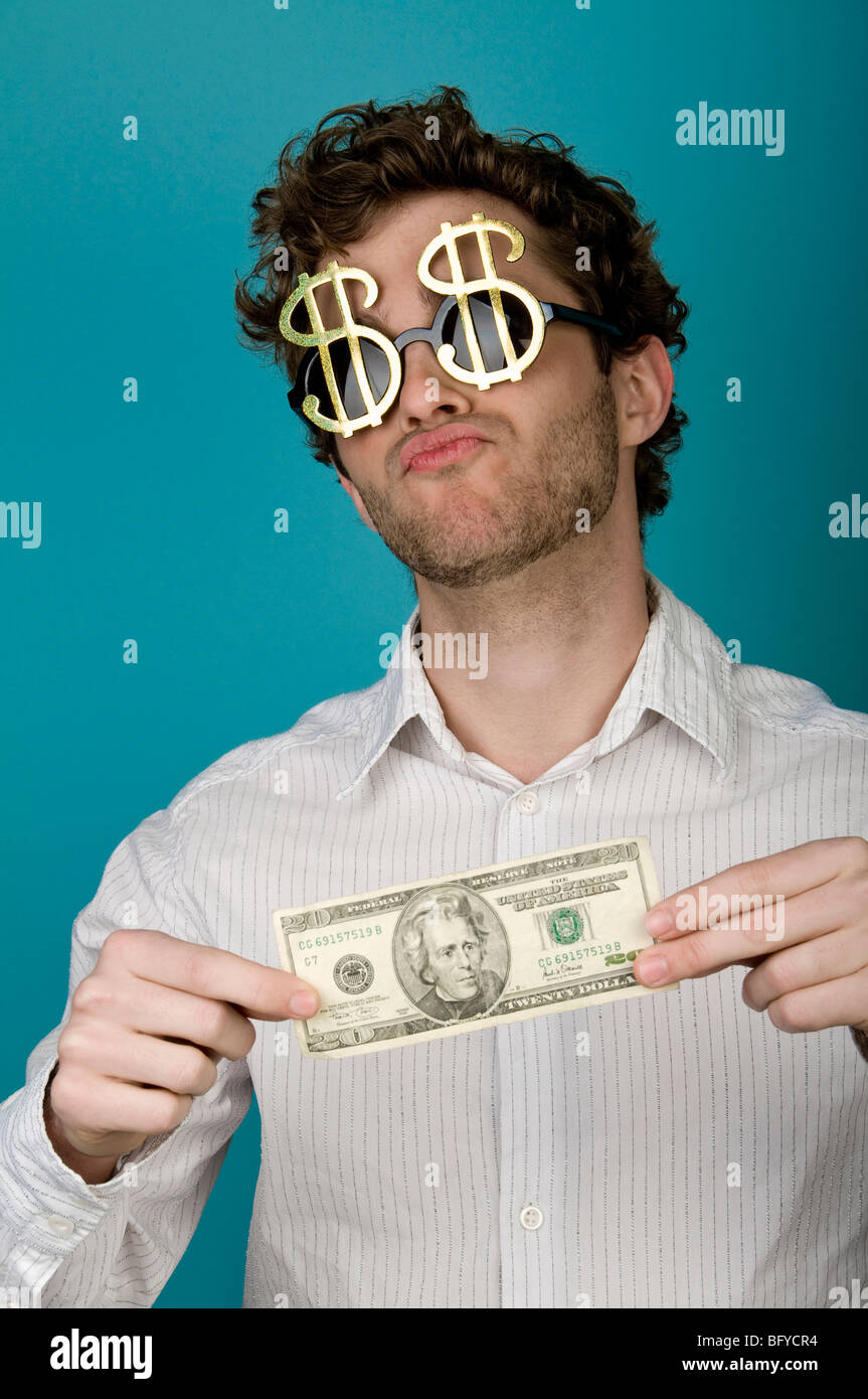 Businessman wearing dollar sign sunglasses and holding money Stock