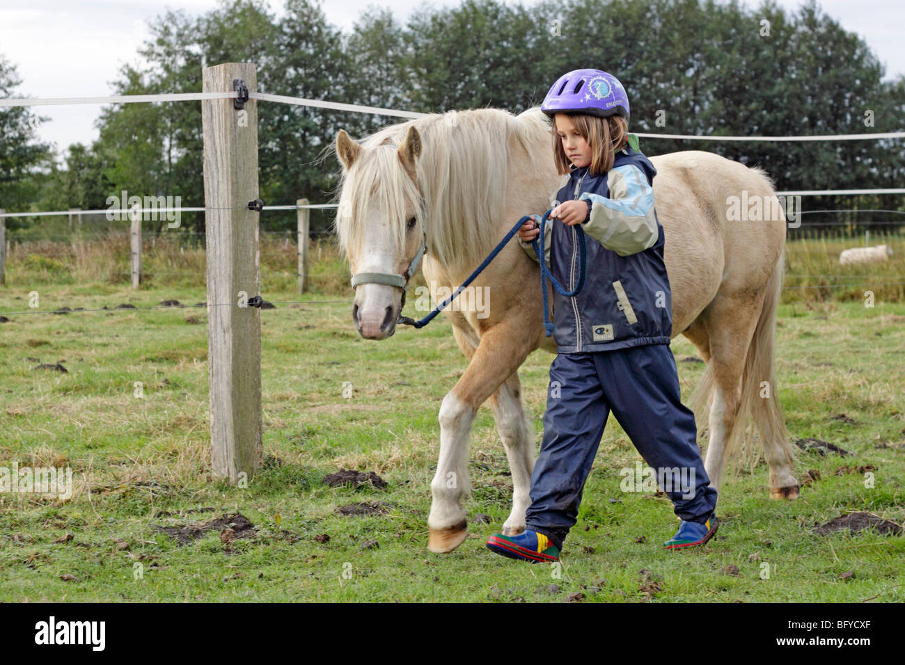 young girl walking with a pony Stock Photo