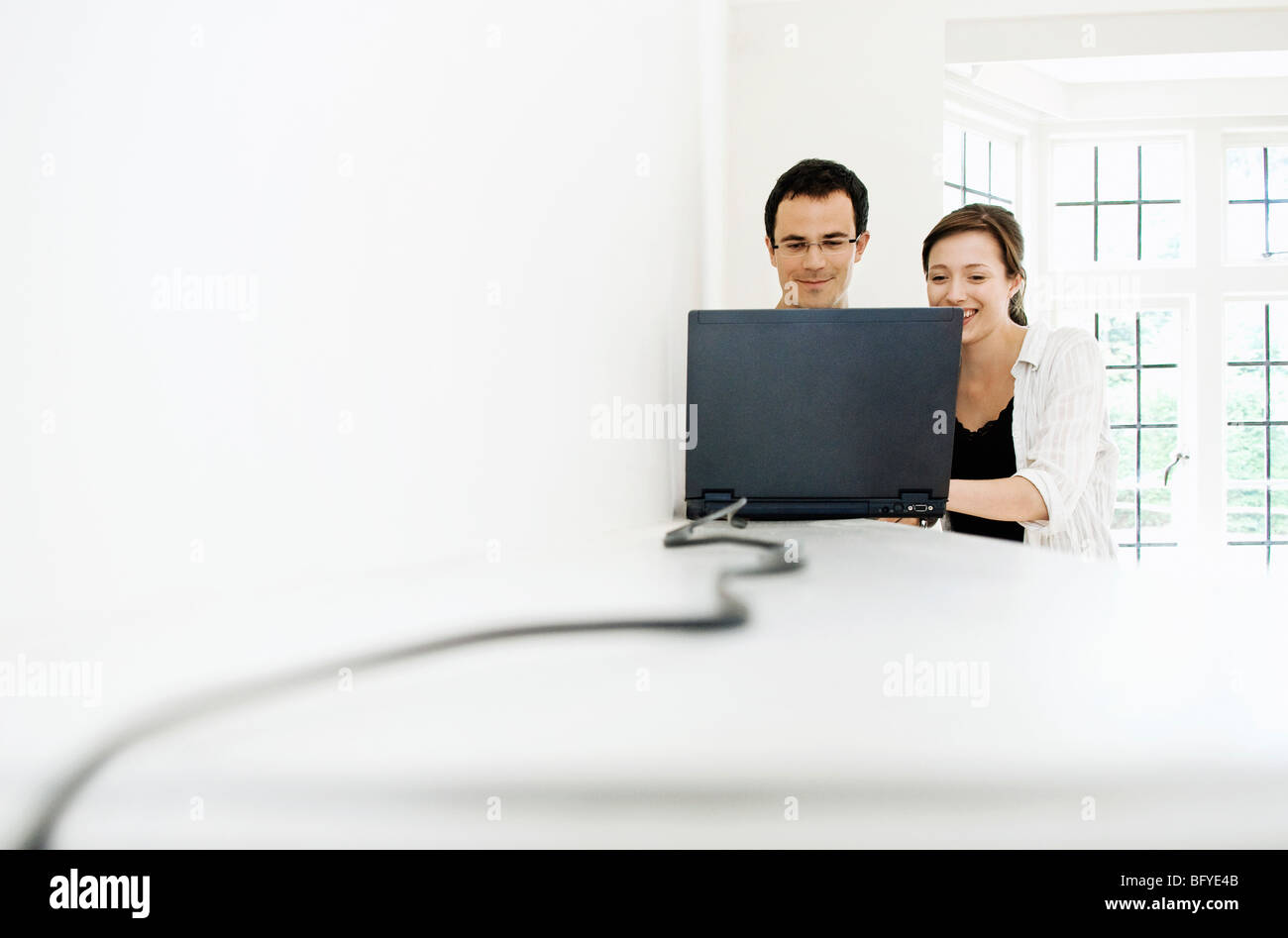 A young couple with a laptop Stock Photo - Alamy