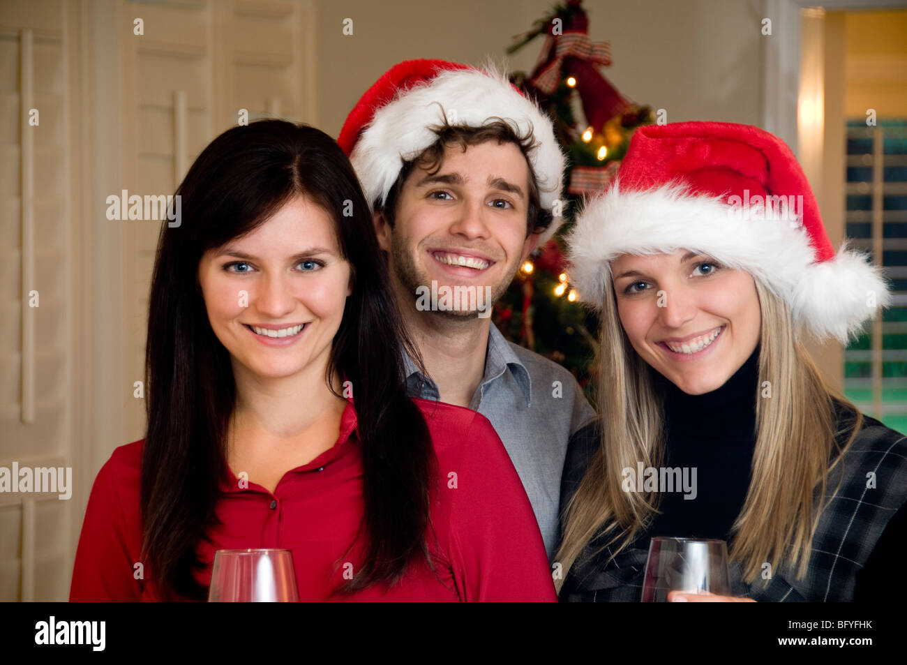 Man and women in Santa hats Stock Photo - Alamy