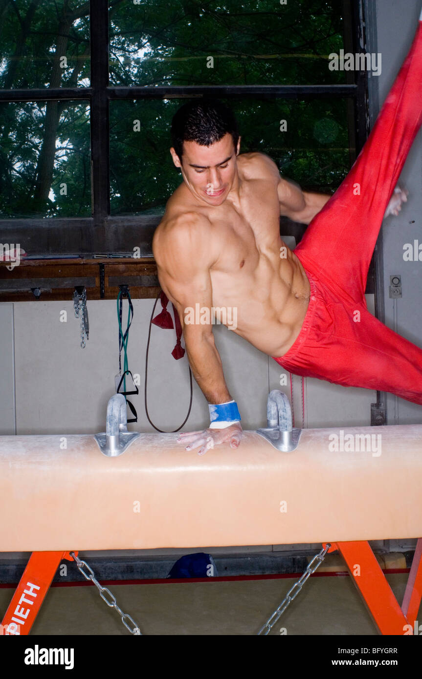Male athlete balancing on pommel horse Stock Photo