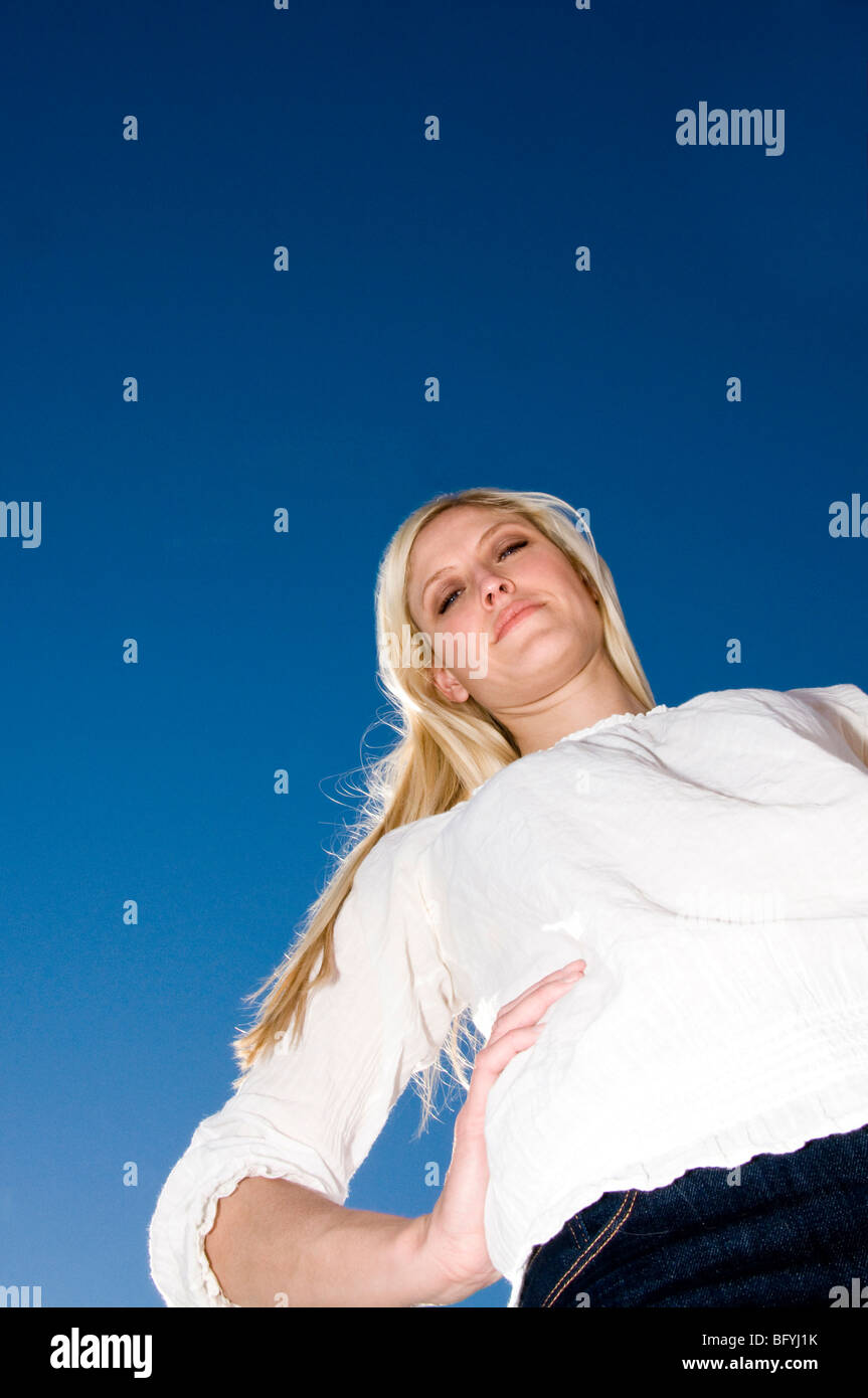 Woman standing with hand on hip Stock Photo - Alamy