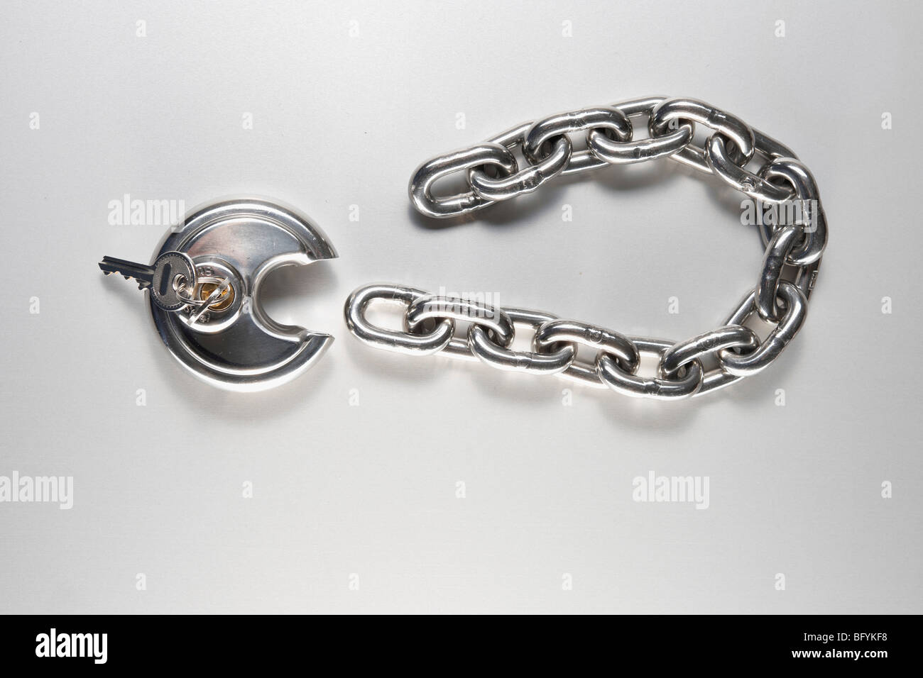 Lock and keys. Closeup of opened metal padlock with key inside isolated on  a white background. Macro photograph of metal lock with keys Stock Photo -  Alamy