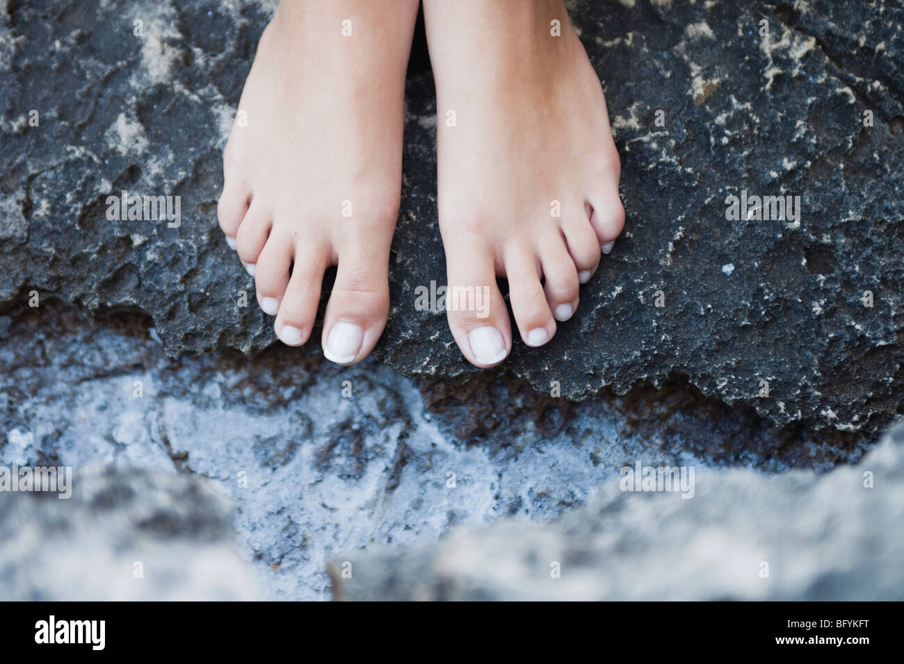 feet of a woman on rocks Stock Photo - Alamy