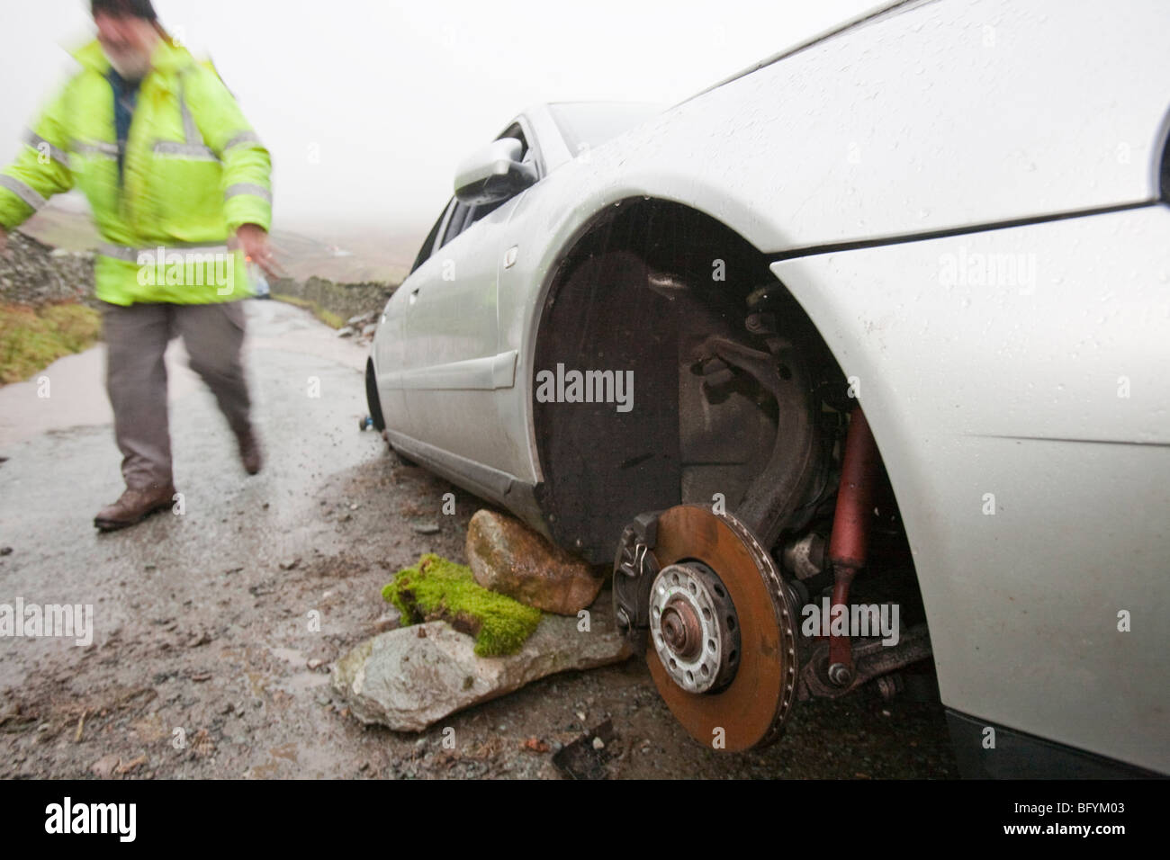 Recovering a car that had its wheels stolen after being abandoned in flood waters near Ambleside, Cumbria, UK. Stock Photo