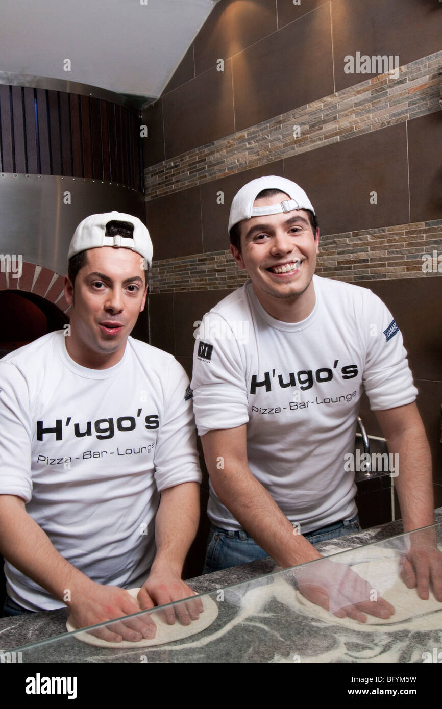 two pizza bakers making dough Stock Photo Alamy