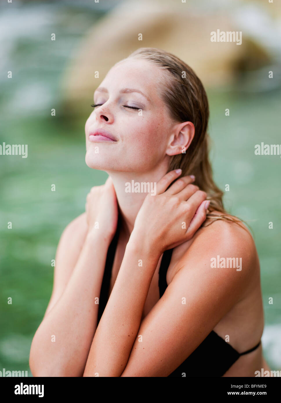 woman sitting on the beach eyes closed Stock Photo