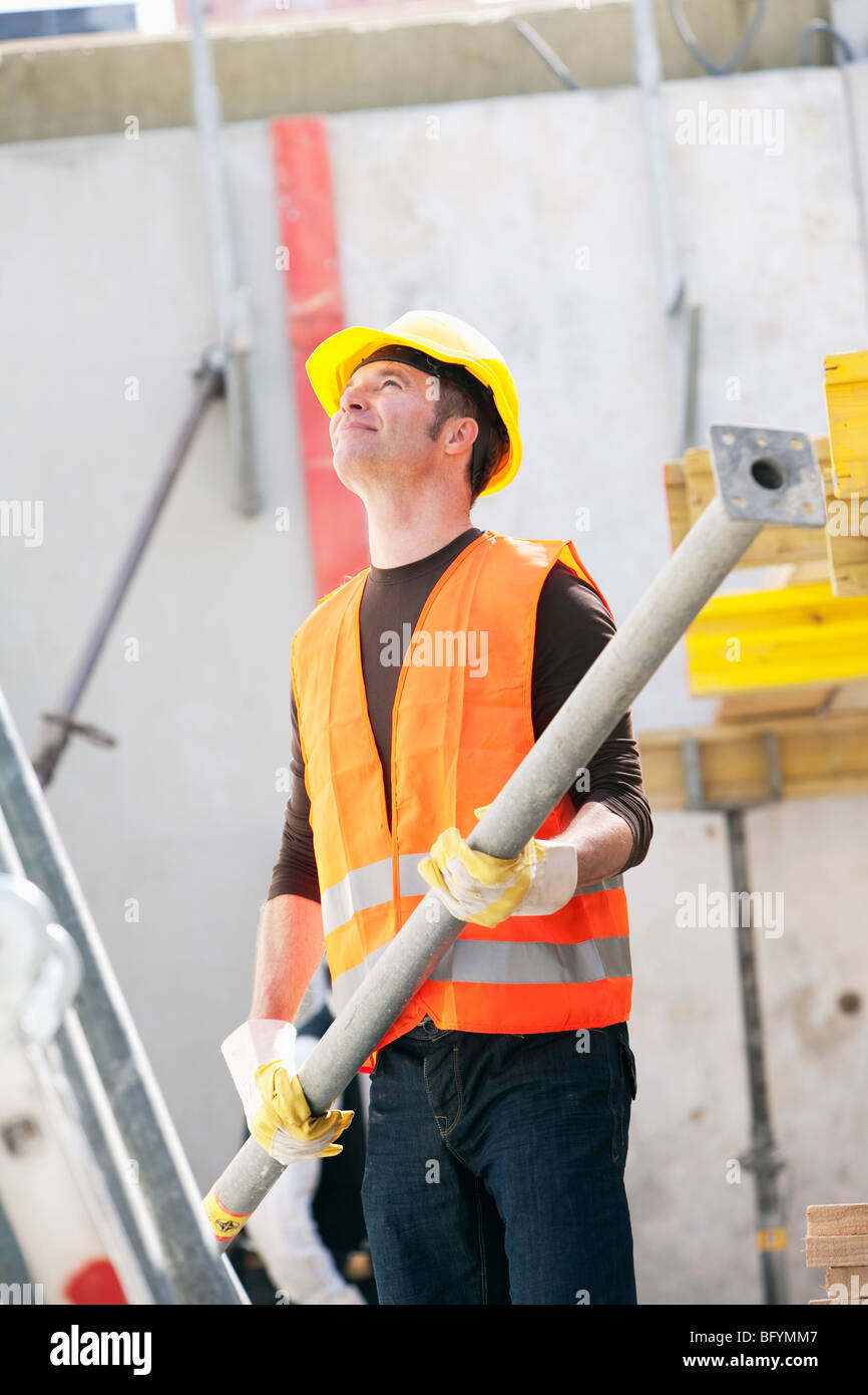construction worker holding metal part Stock Photo