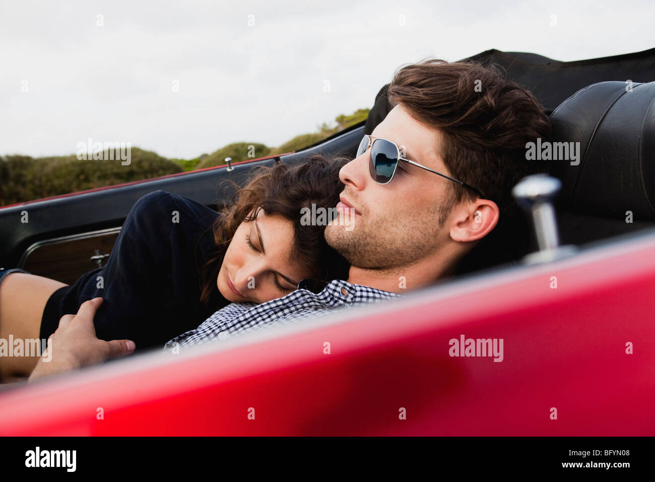 couple lying in car sleeping Stock Photo