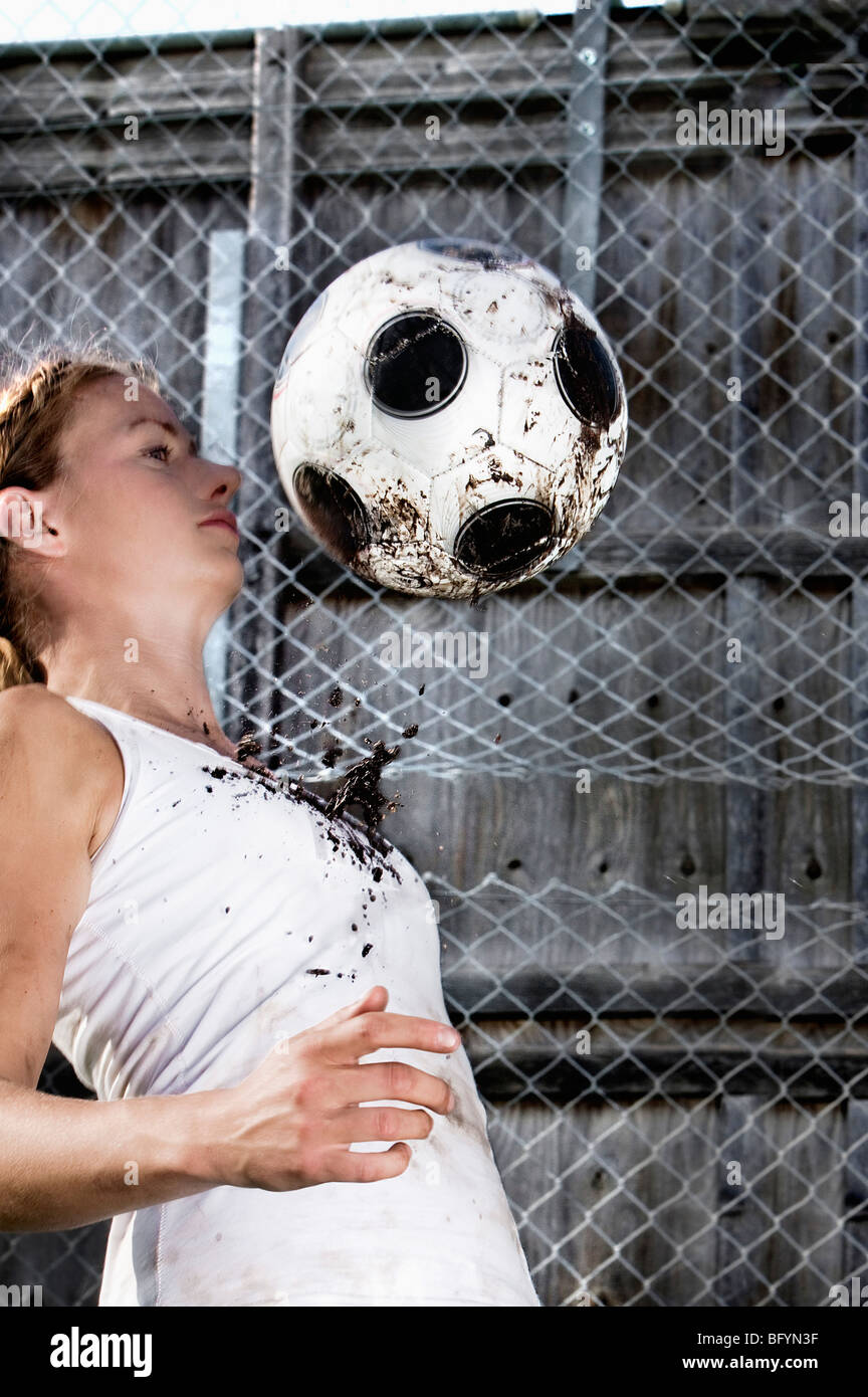 young woman practising with football Stock Photo
