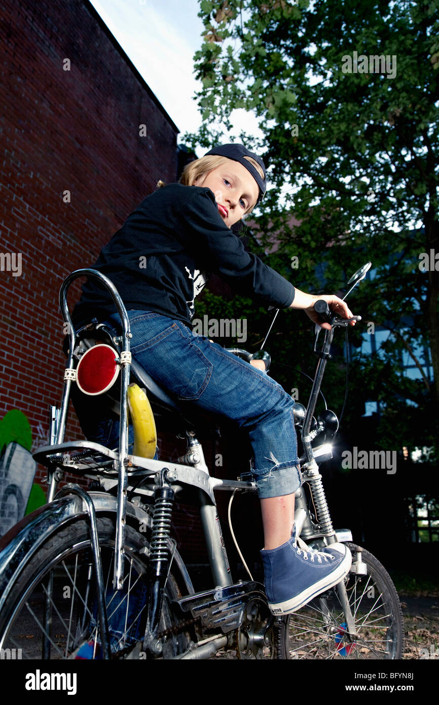 portrait of blond boy on chopper bicycle Stock Photo