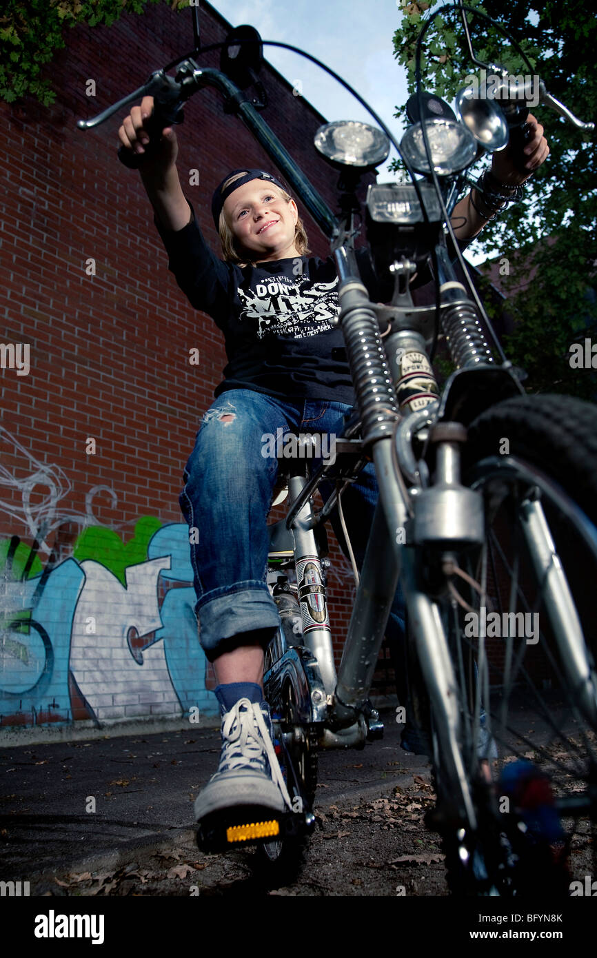 portrait of blond boy on chopper bicycle Stock Photo
