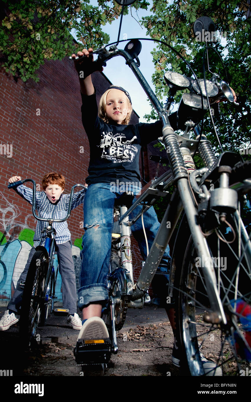 portrait of two young boys on chopper bicycles Stock Photo