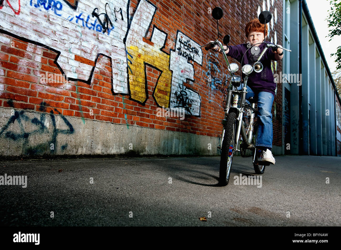 red haired boy on chopper bicycle Stock Photo
