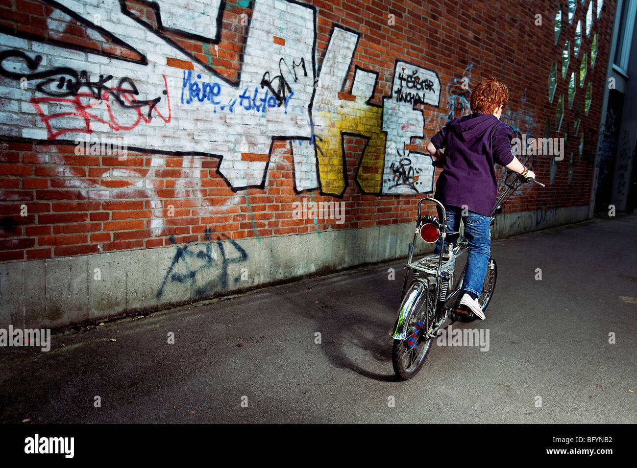 red haired boy on chopper bicycle Stock Photo