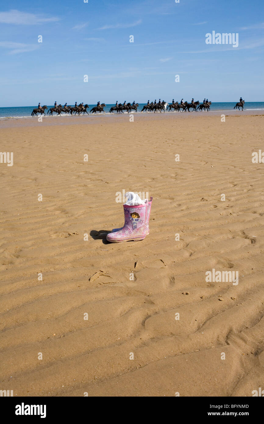 A Dora the Explorer children's pink wellington boot on the beach. Stock Photo