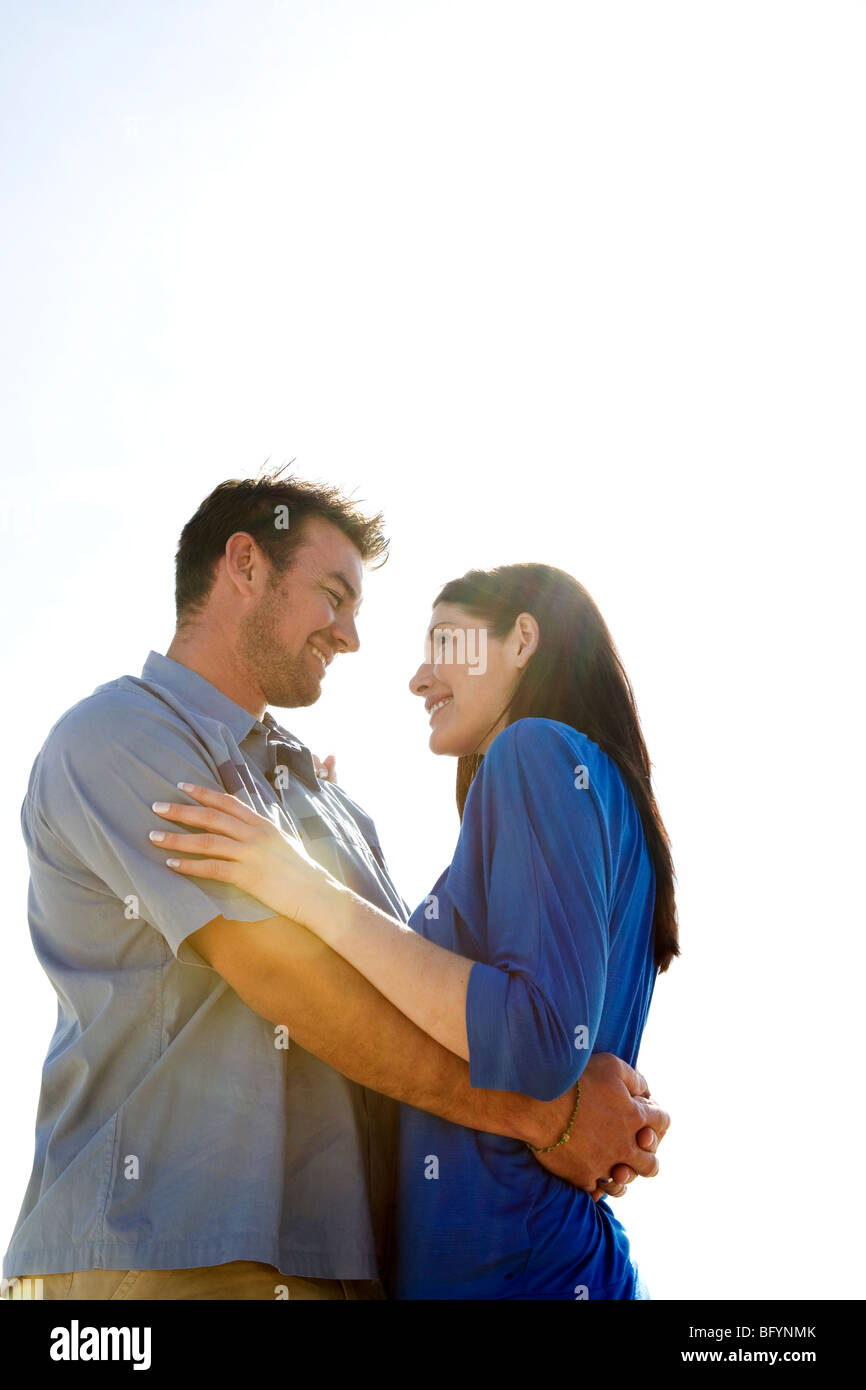 Mid adult couple embracing on the beach Stock Photo - Alamy