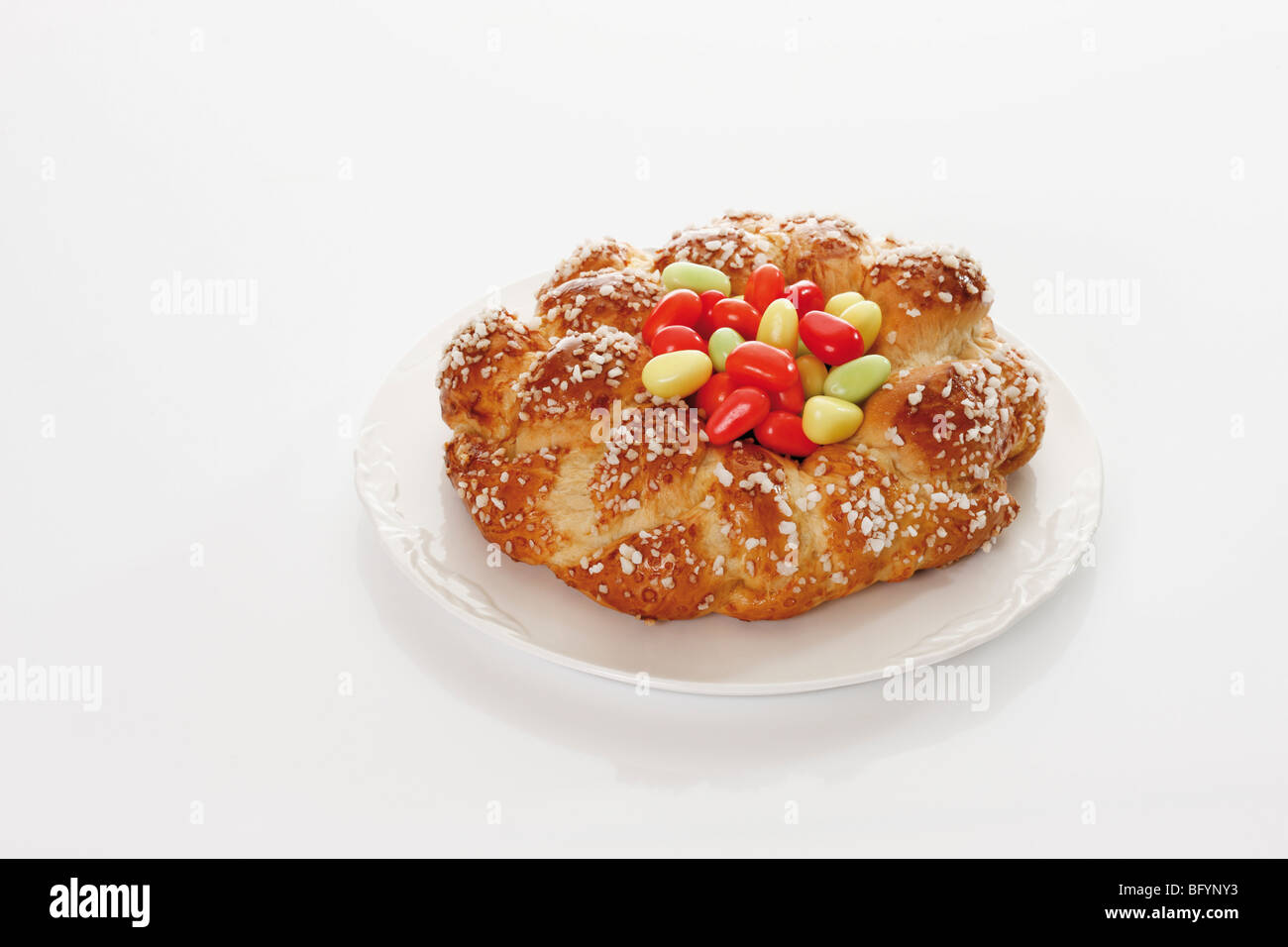 Savarin with sugar Easter eggs on a plate Stock Photo