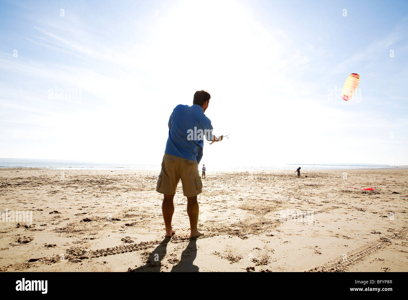 A man flying a kite at the beach Stock Photo Alamy