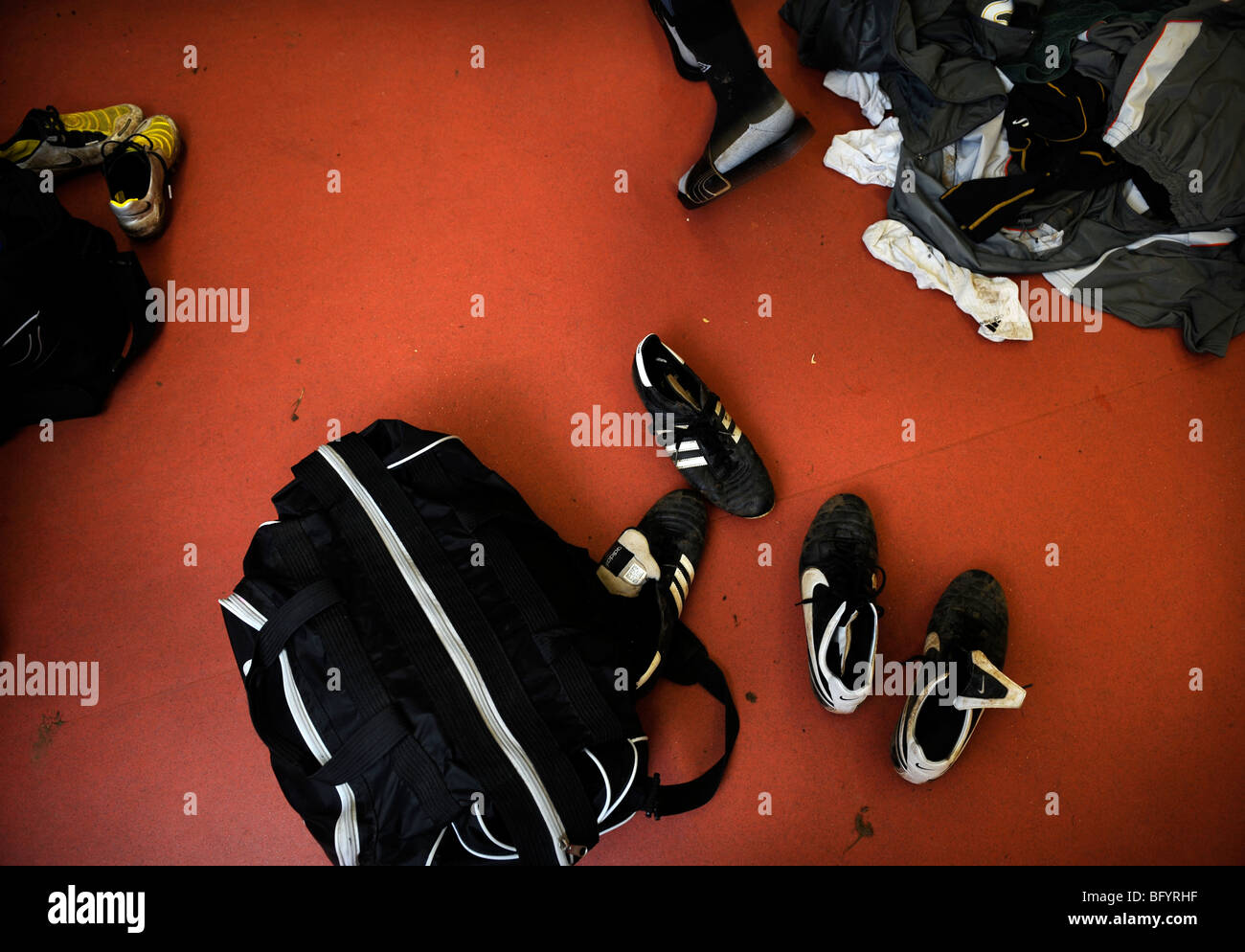 A footballers changing room with dirty kit piled on the floor UK Stock Photo