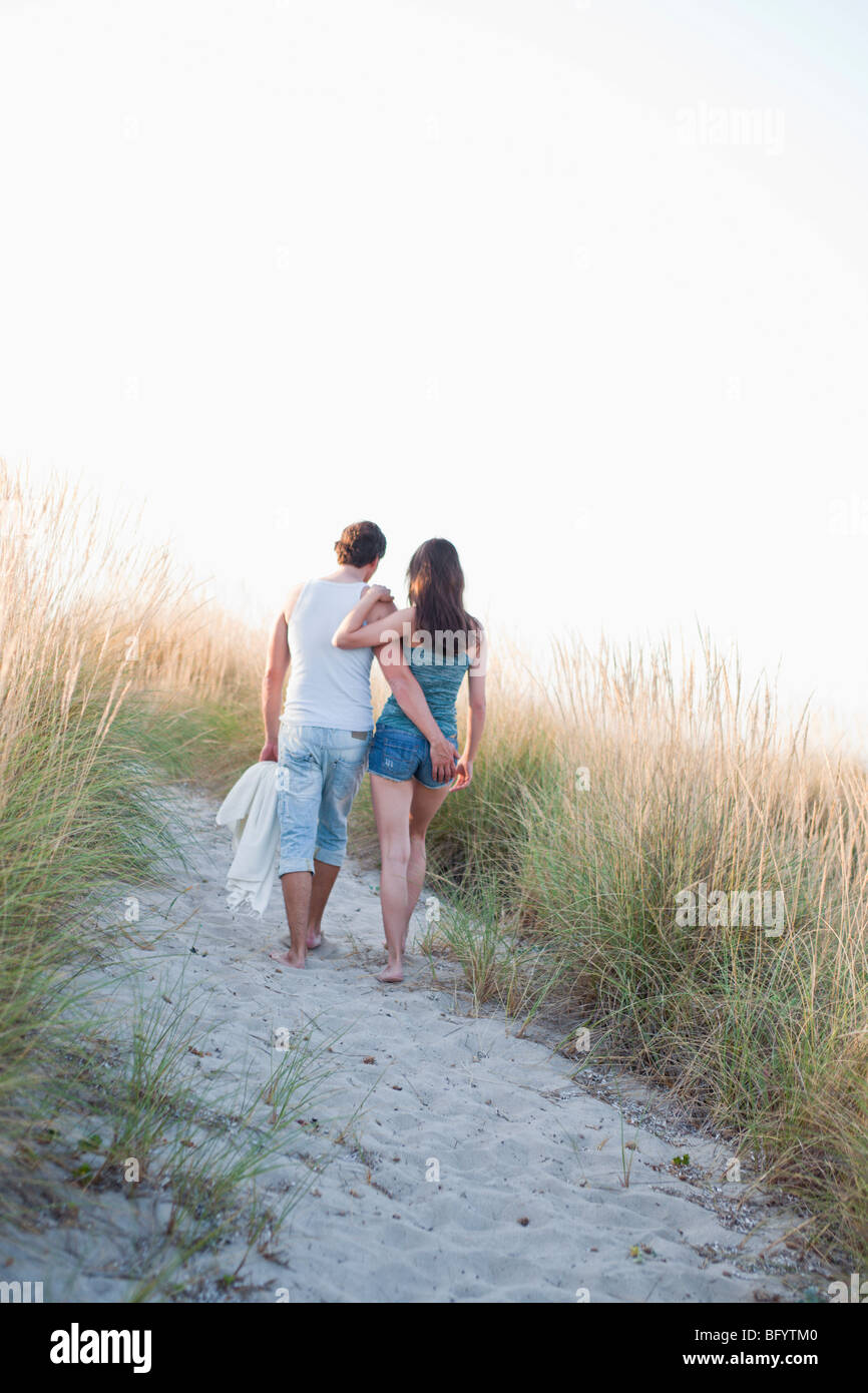 couple strolling along beach Stock Photo