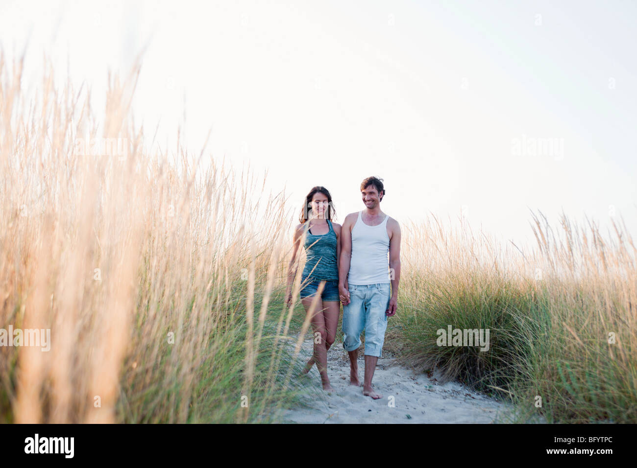 couple strolling along beach Stock Photo