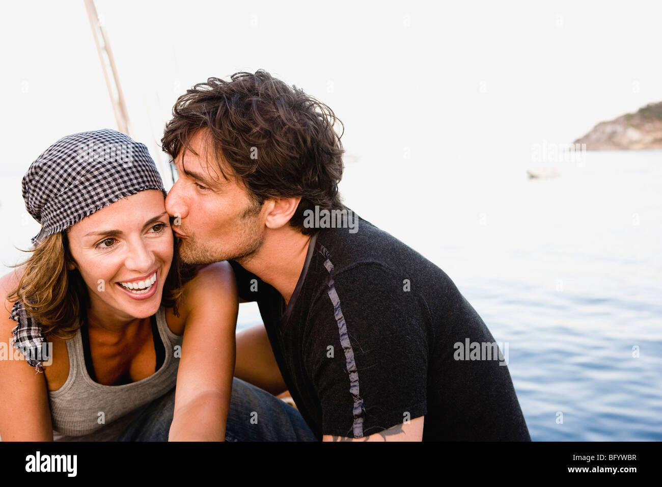 couple kissing on deck Stock Photo