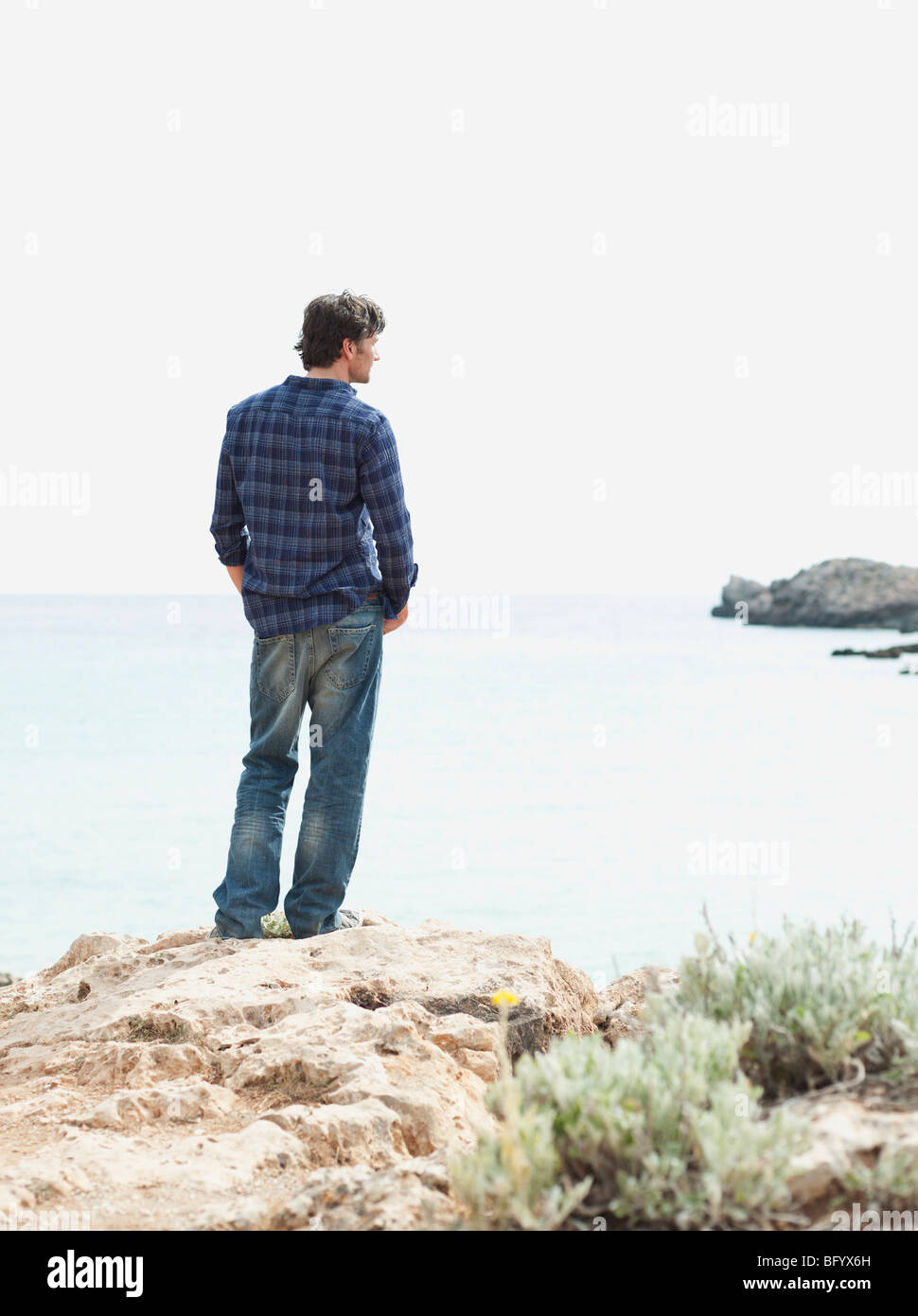 man looking at coastline Stock Photo