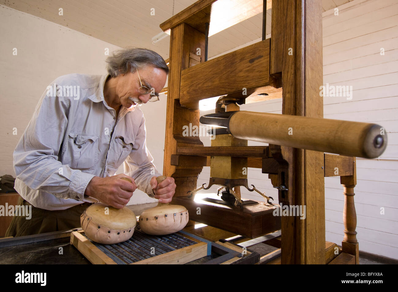Setting up a working model of an 18th C printing press. Stock Photo