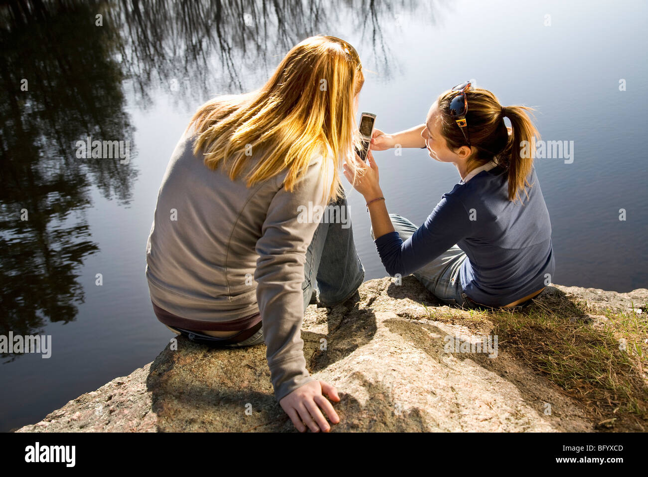 Woman reading phone rear view hi-res stock photography and images - Alamy