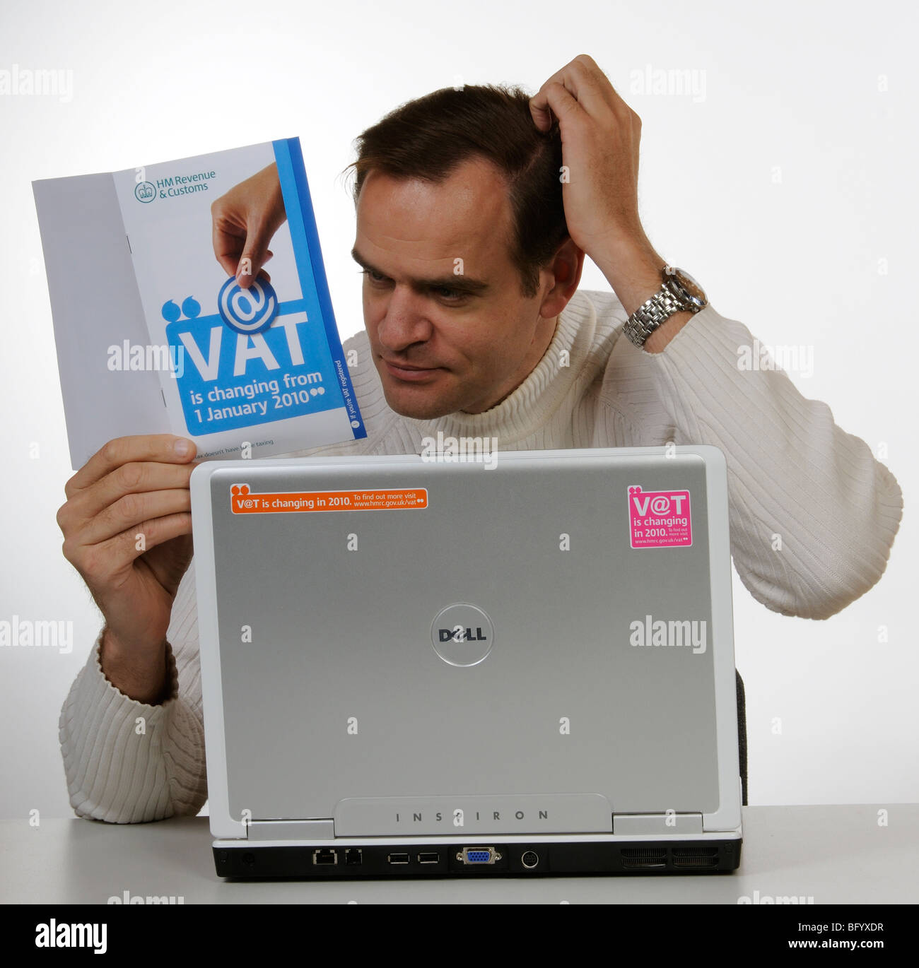 VAT changes for 2010 man studying HM Revenue & Customs information booklet Stock Photo