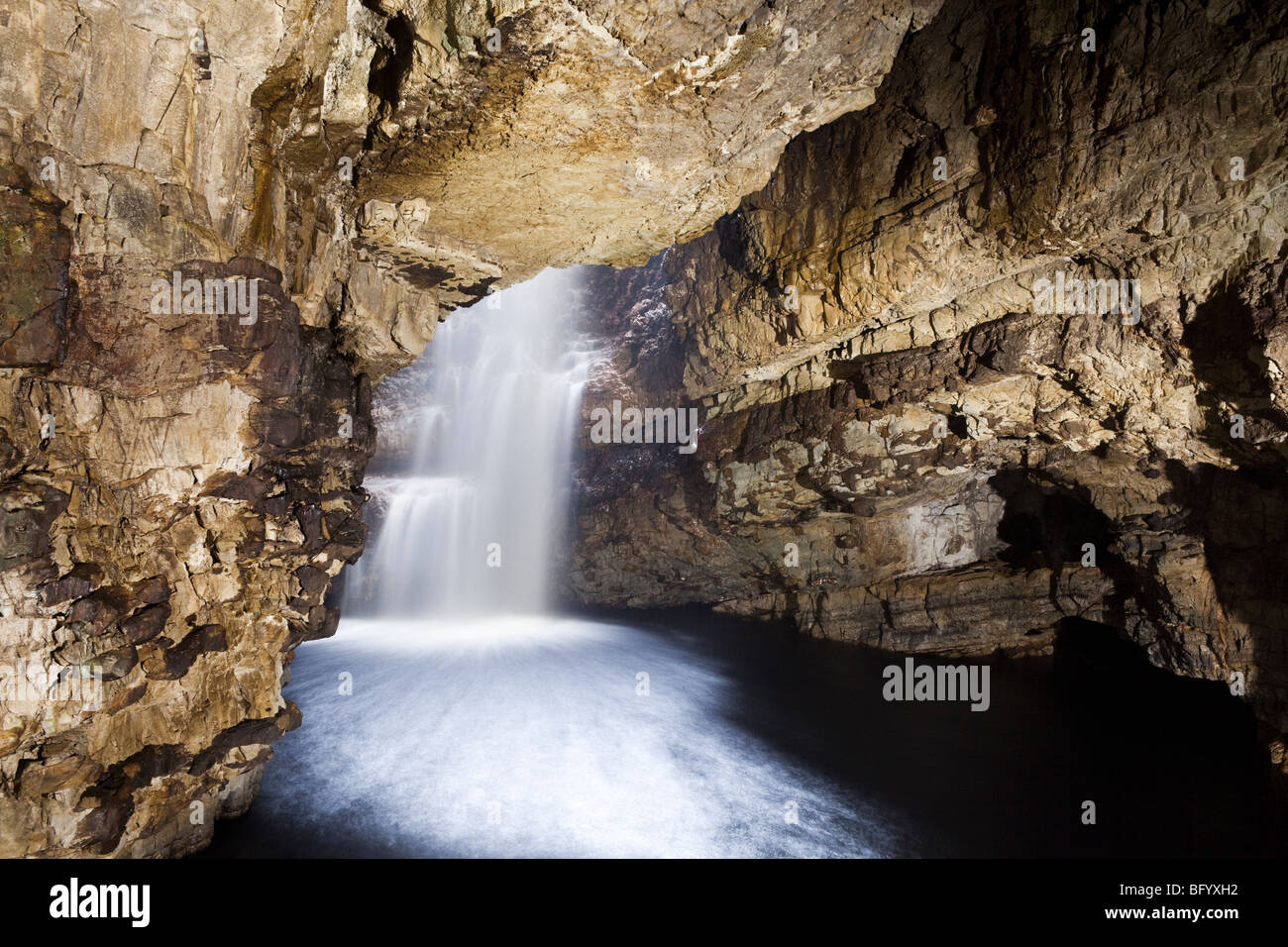 The river Allt Smoo falling through a sink hole into Smoo Cave at Durness, Highland, Scotland Stock Photo