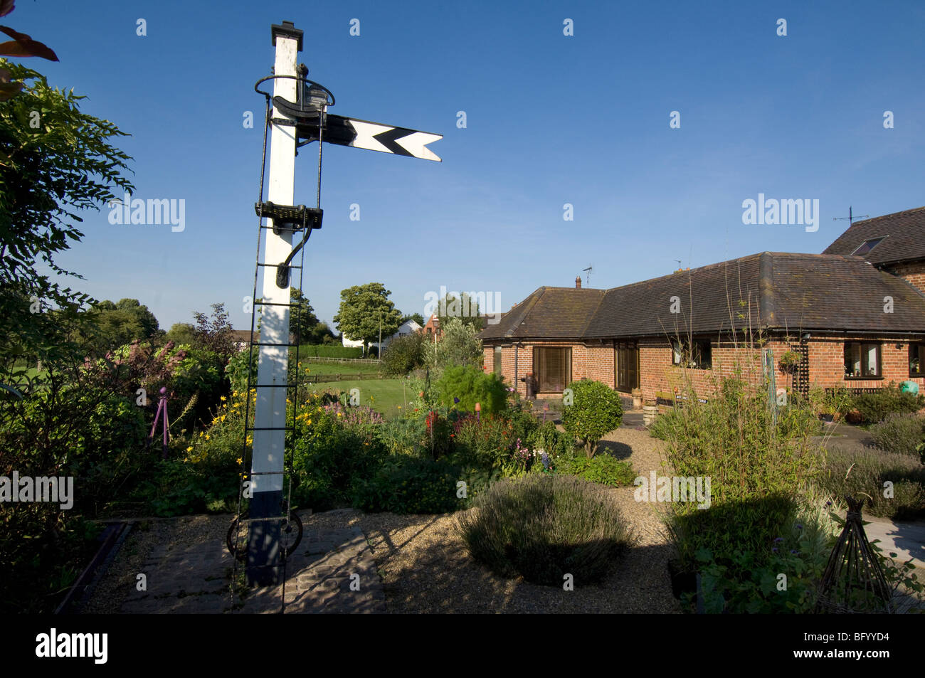 A preserved railway signal in a rail enthusiast's garden, part of a collection of railwayana. Stock Photo