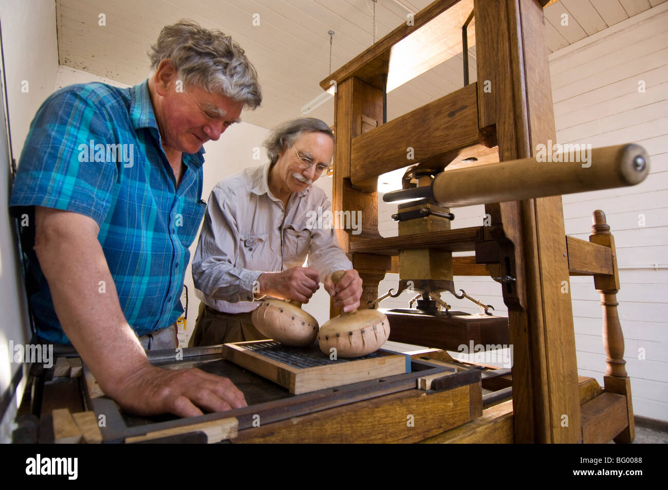 Alan May (left) and Peter Chasseaud (right) set up a working model of an 18th C printing press. Stock Photo
