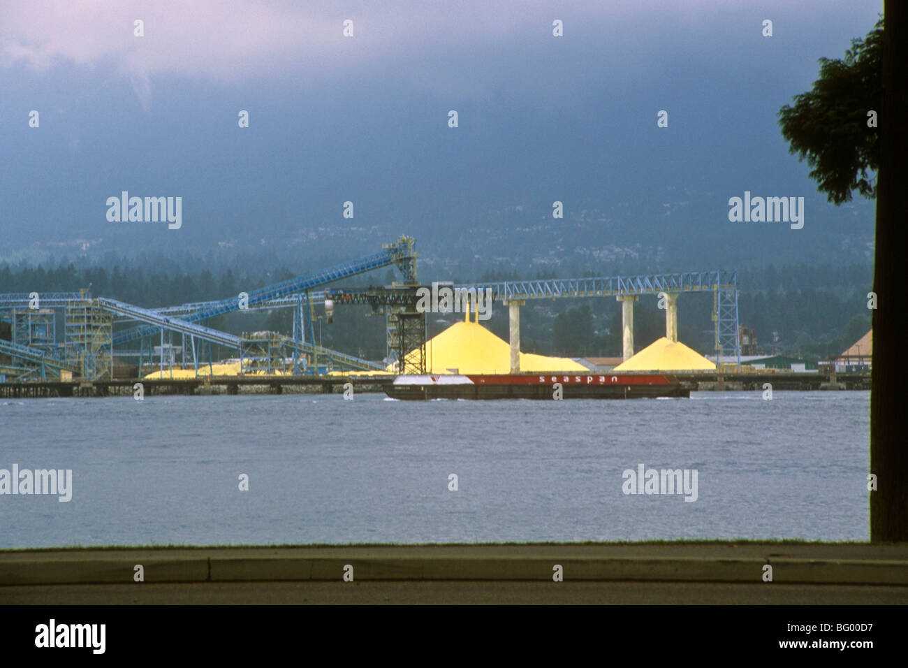 British Columbia chemical transport barge conveyor pile storage Stock Photo