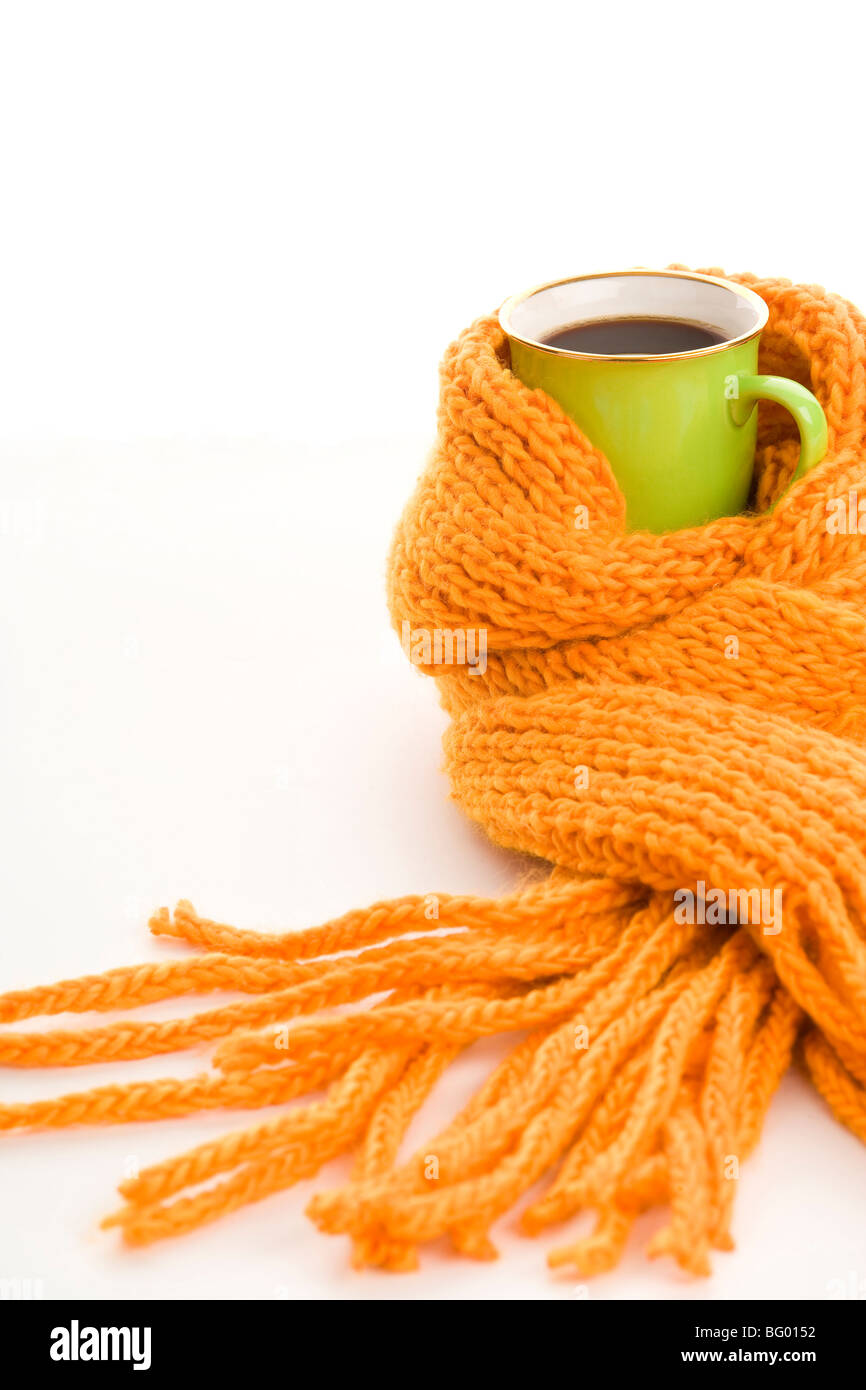 Green mug wrapped yellow scarf isolated on white background Stock Photo