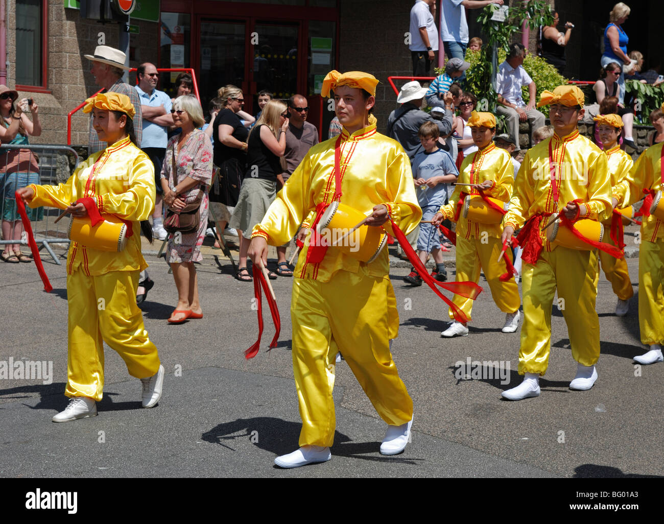 members of the ancient chinese culture 'falun gong ' marching through the streets of penzance,cornwall,uk Stock Photo