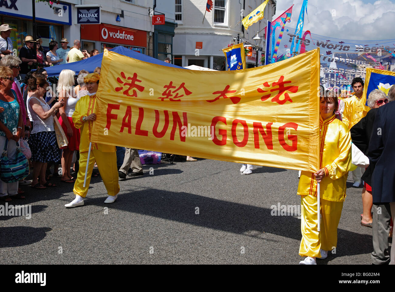members of the chinese cult 'falun gong ' marching through the streets of penzance in cornwall, uk Stock Photo