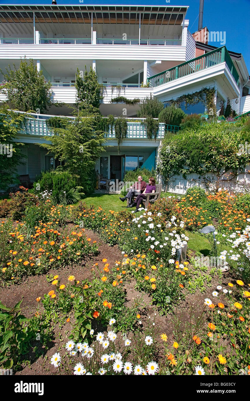 Guests enjoy flower gardens that surround Sooke Harbour House, an