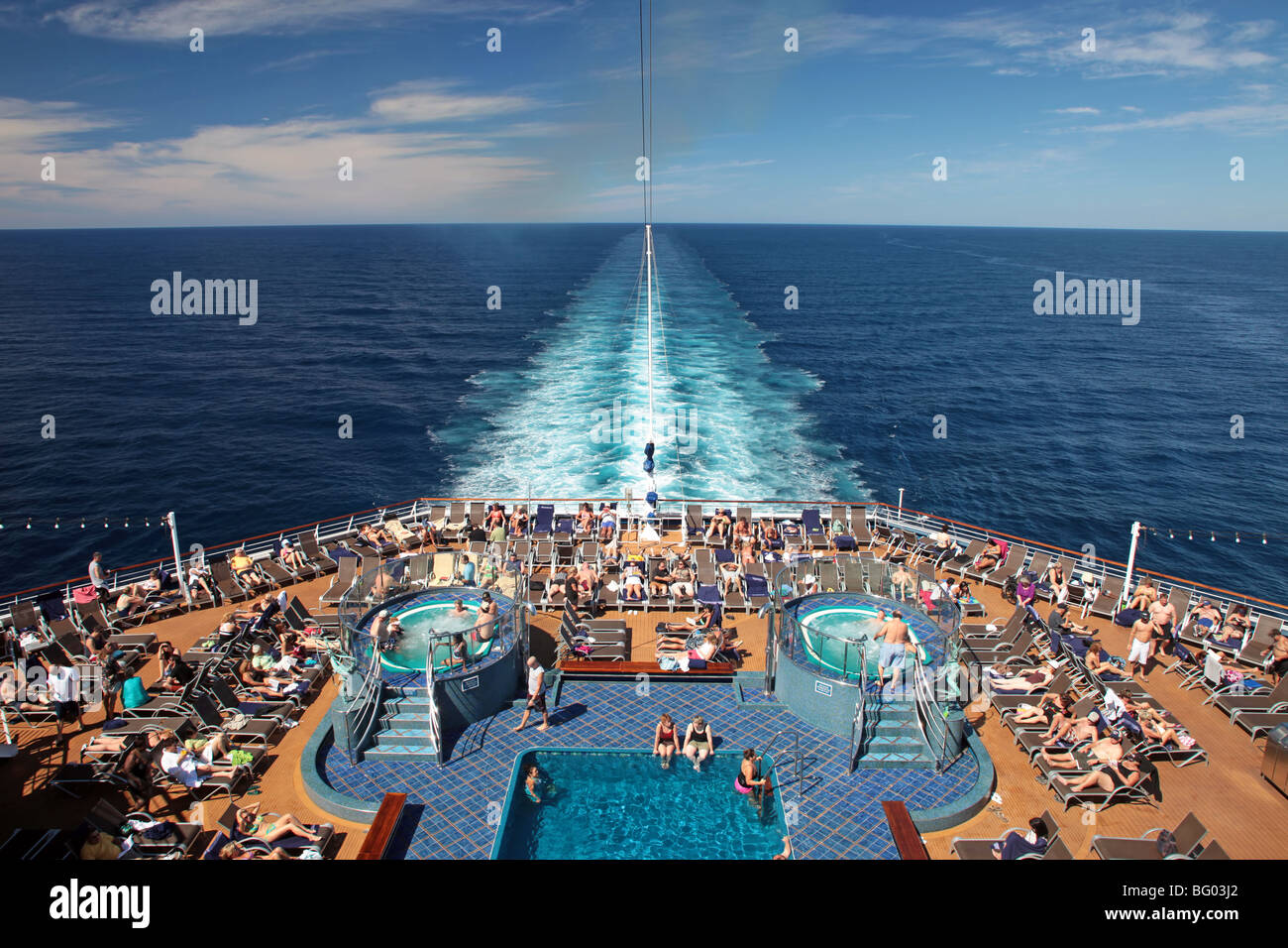 Cruise ship rear deck swimming pools and hot tubs. Ocean wakes