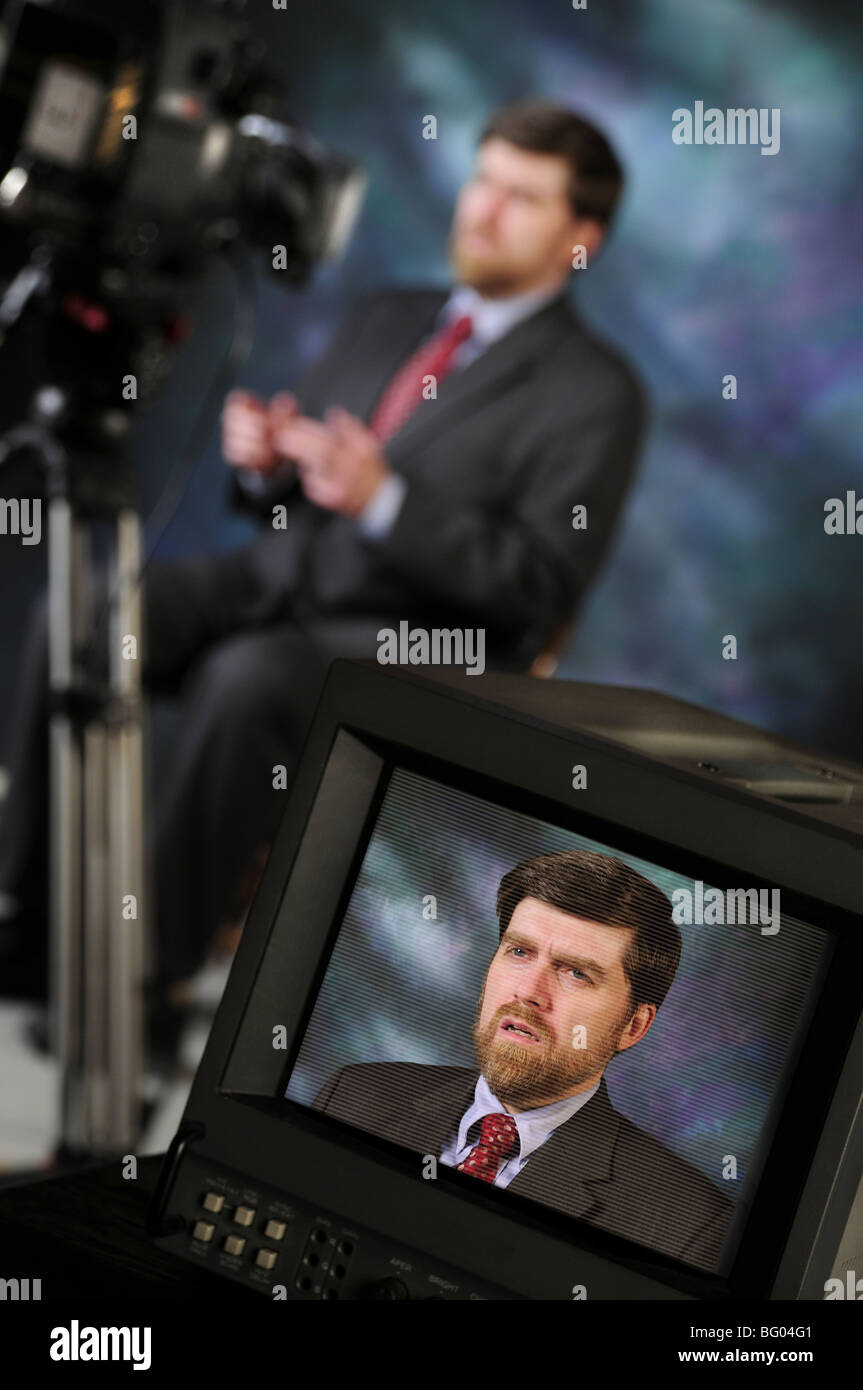 Monitor in production studio showing newsman or pundit talking to television or video camera Stock Photo