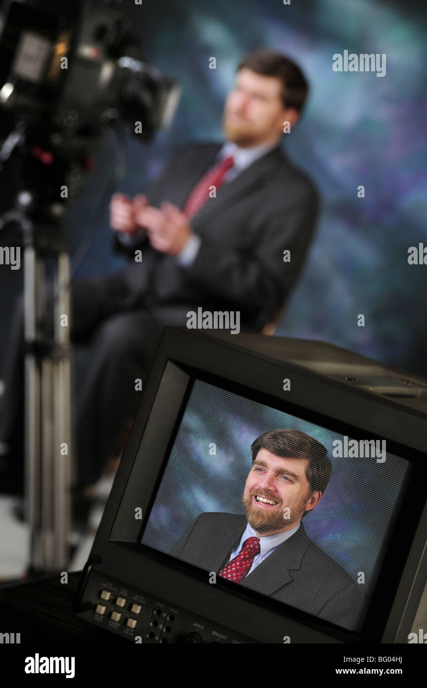 Monitor in production studio showing newsman or pundit talking to television or video camera Stock Photo